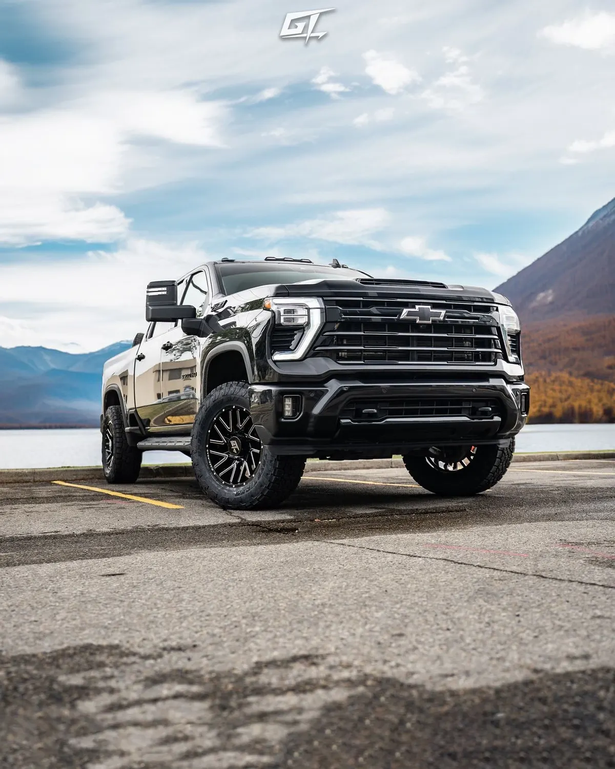 GMC Sierra on GT Off-Road Aggression wheels with a mountain backdrop